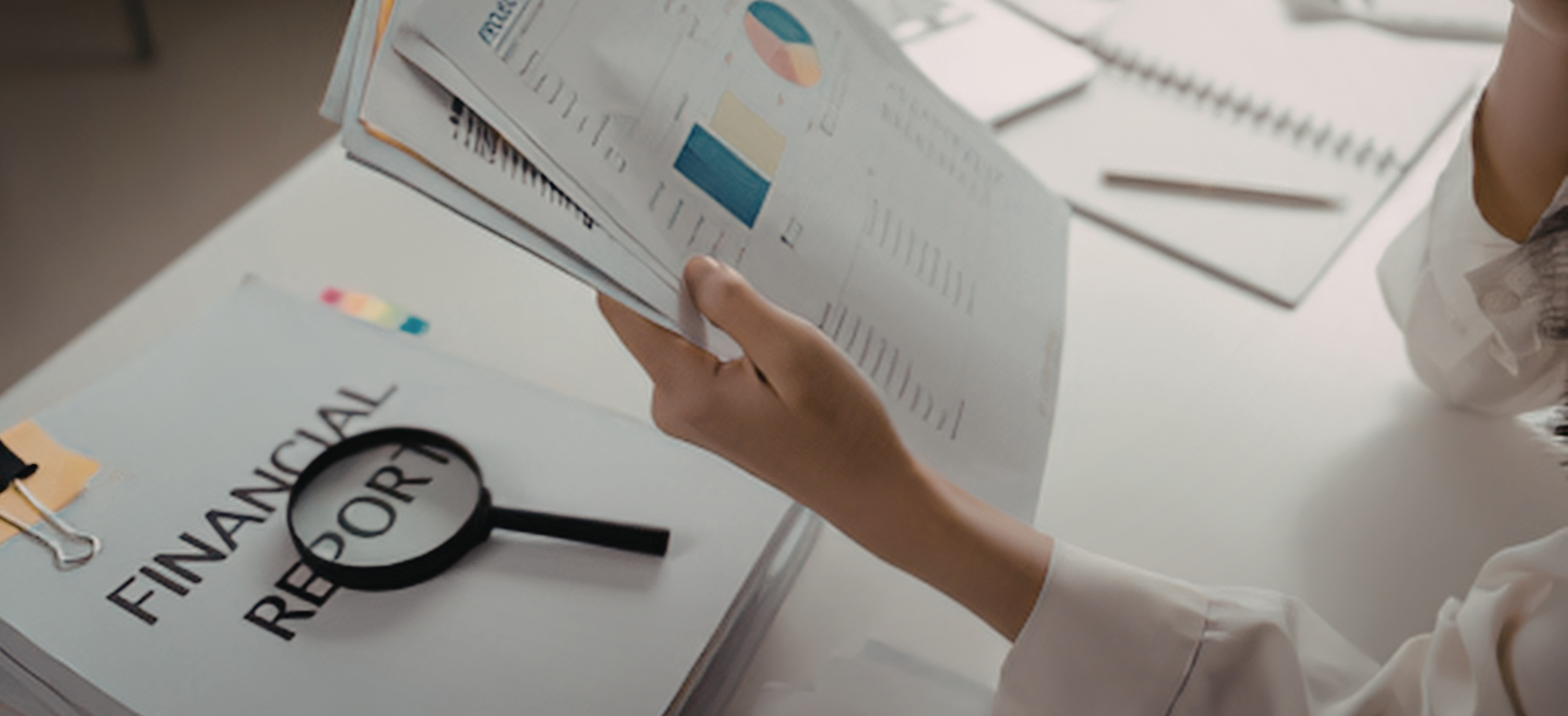 Attorney reviewing financial reports and charts at a desk, representing tax planning for law firms