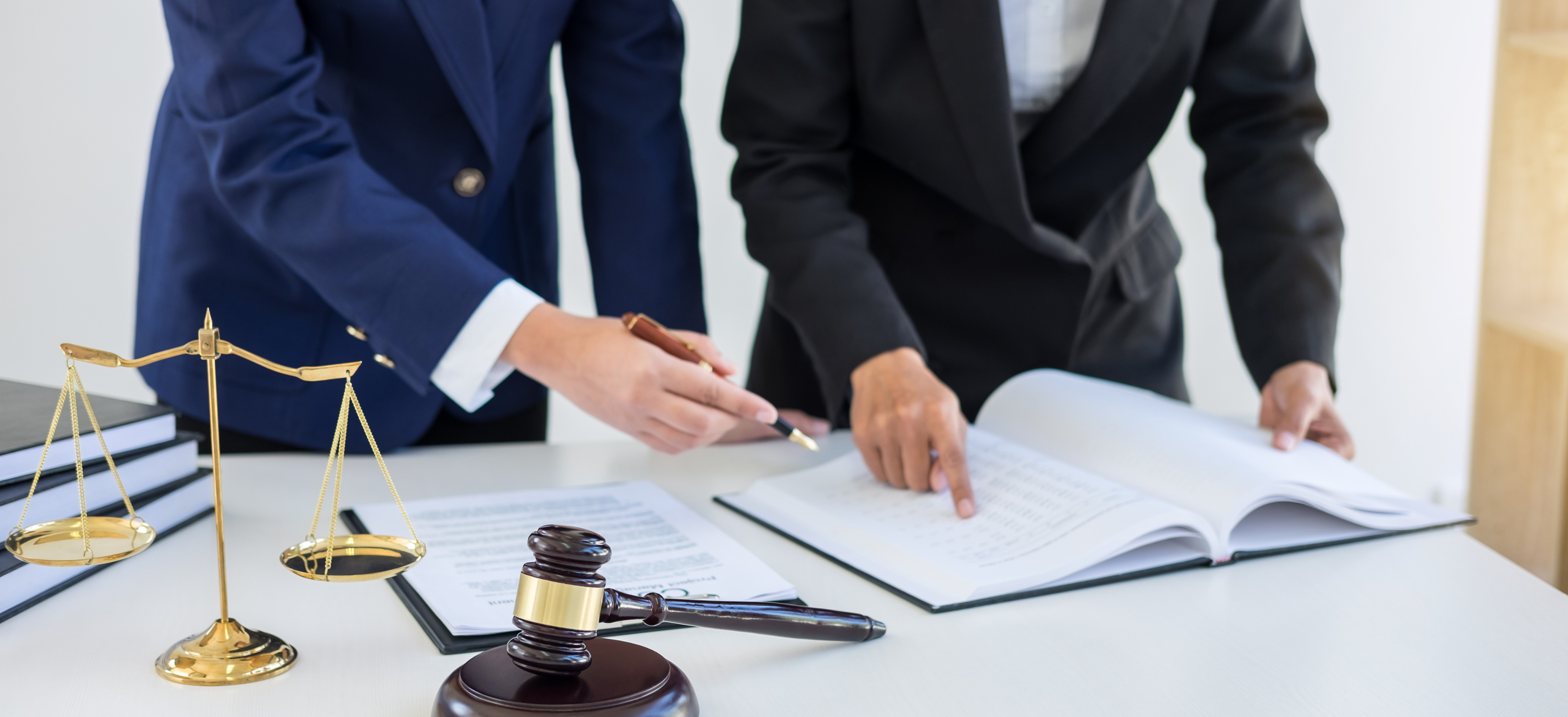 Law firm professionals reviewing documents together in an office, representing tax compliance and financial planning
