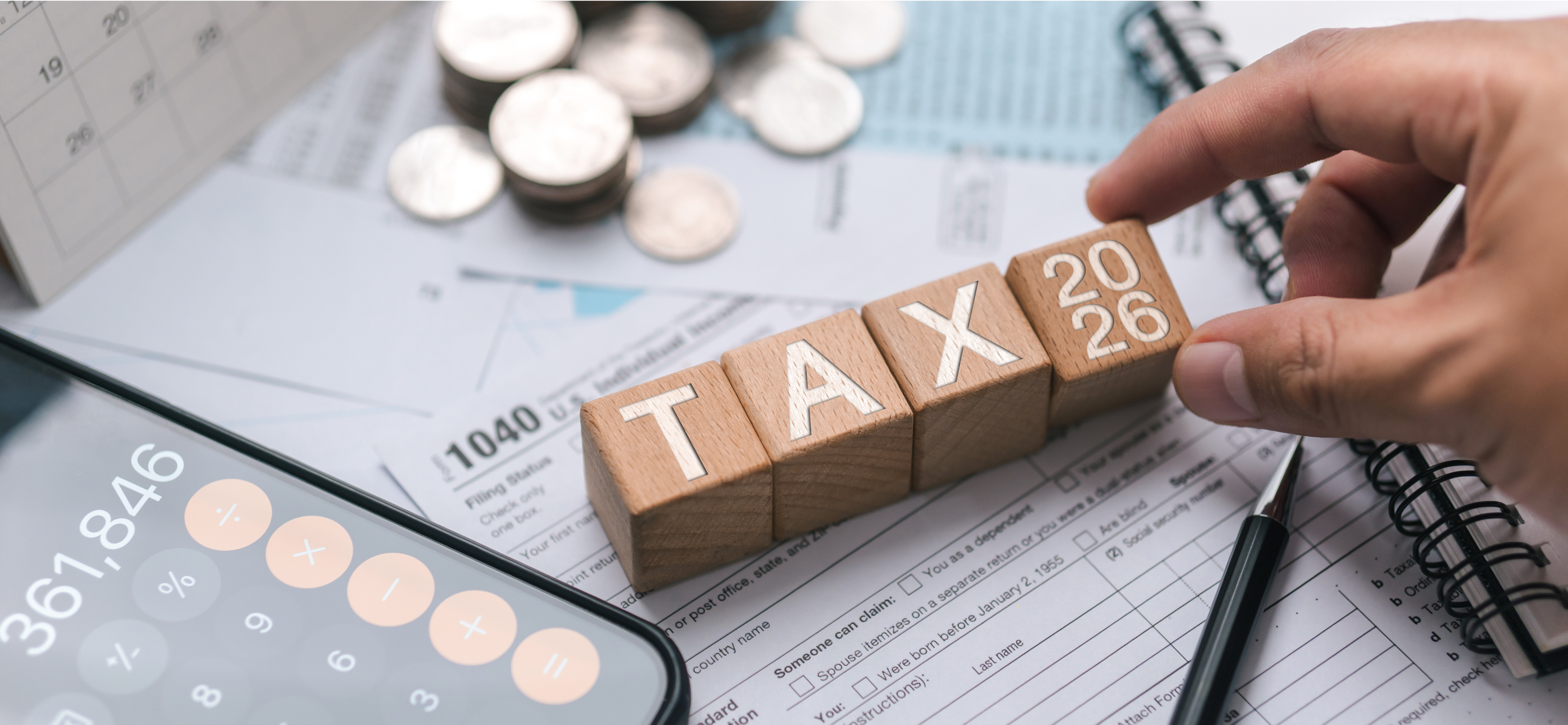 Attorney tax planning concept with 2026 tax blocks, Form 1040, and calculator