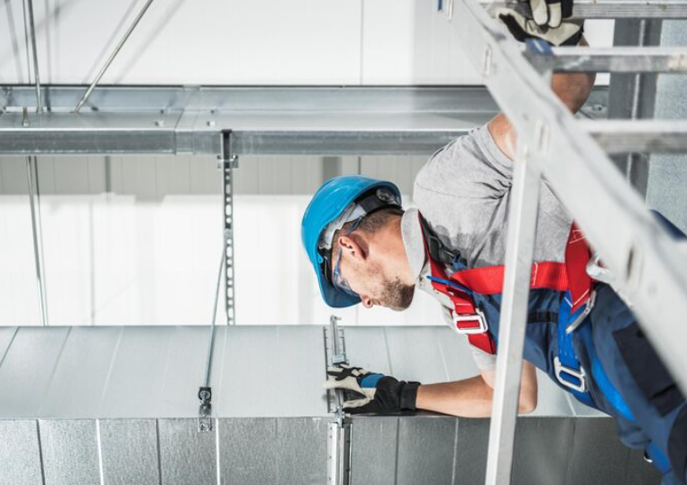 Professional hvac contractor checking on newly installed commercial air duct