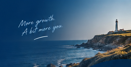Lighthouse above the coast with the handwritten message ‘More growth. A bit more you.’
