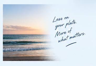 Sunrise over the coast with the handwritten message ‘Less on your plate. More of what matters.’