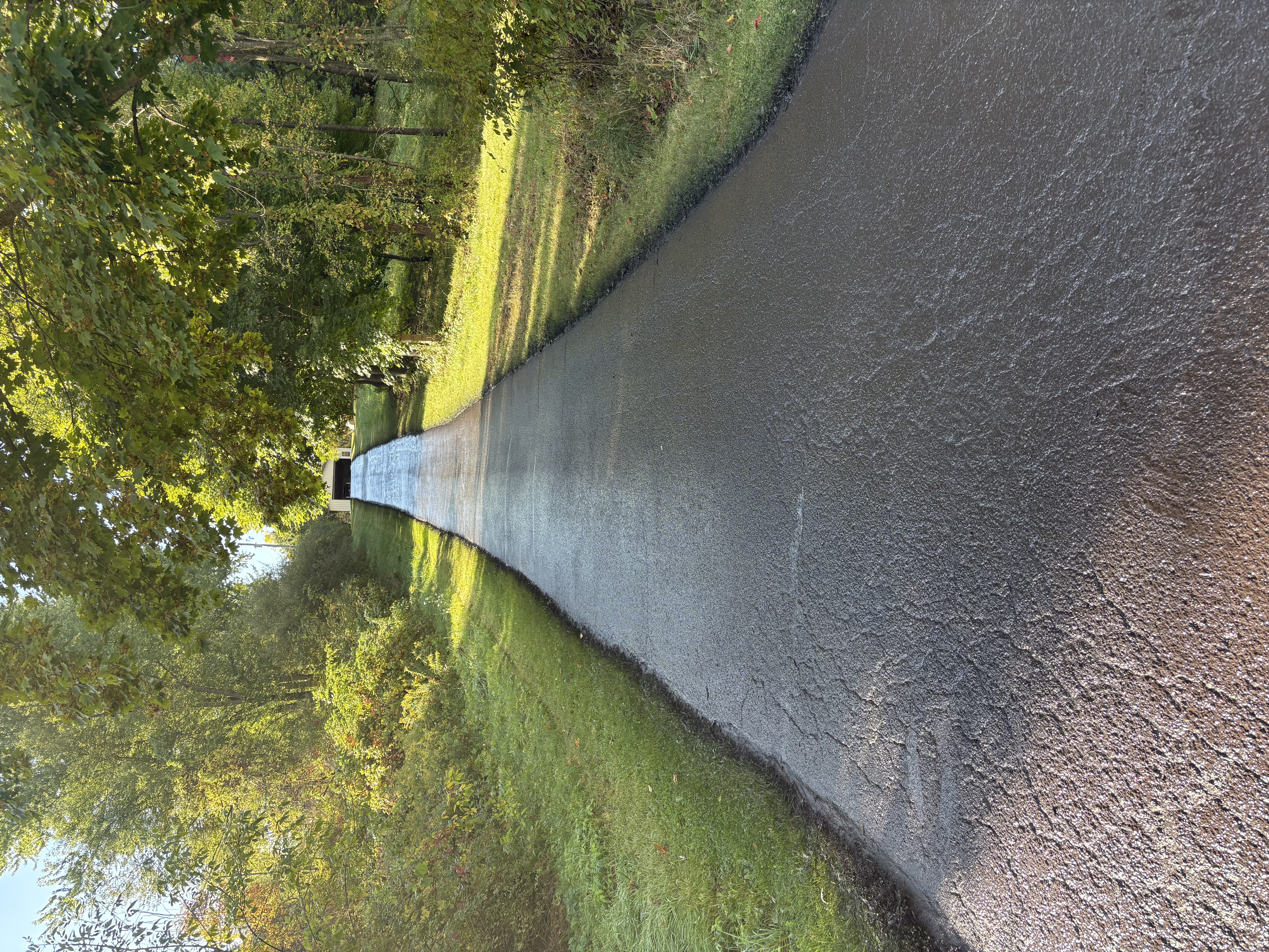 Fresh sealcoat application on residential pavement