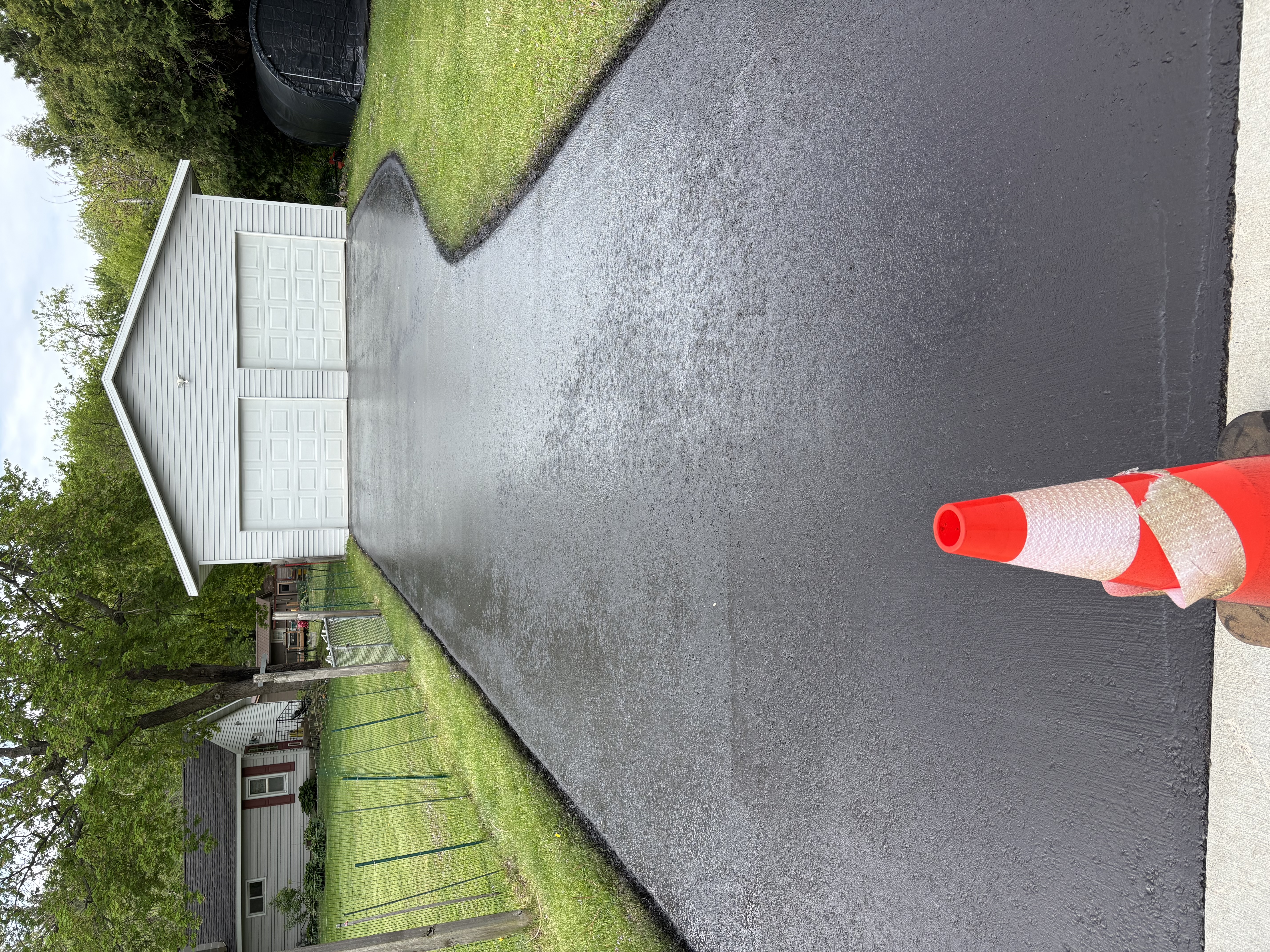 Freshly sealed residential driveway with protective coating