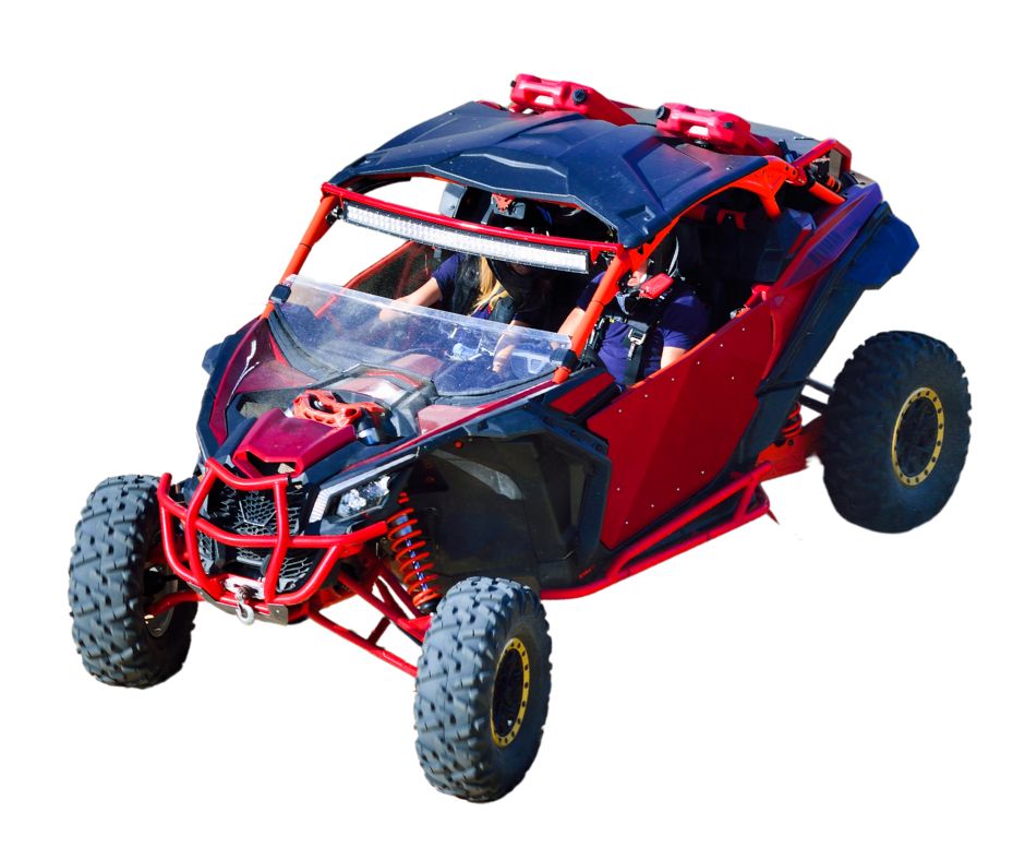 A red and black off-road UTV vehicle with four large, rugged tires, featuring a roll cage, a windshield, and red fuel cans mounted on top.