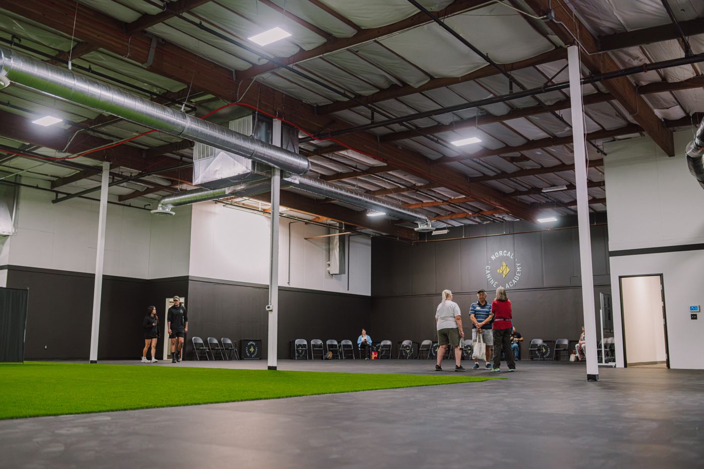 The indoor training floor, artificial turf under a high steel roof