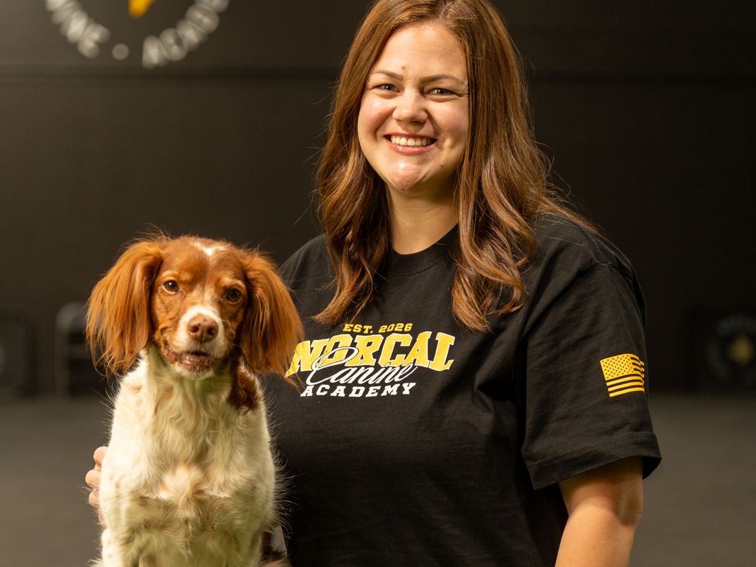 Mackenzi at the academy holding her Brittany