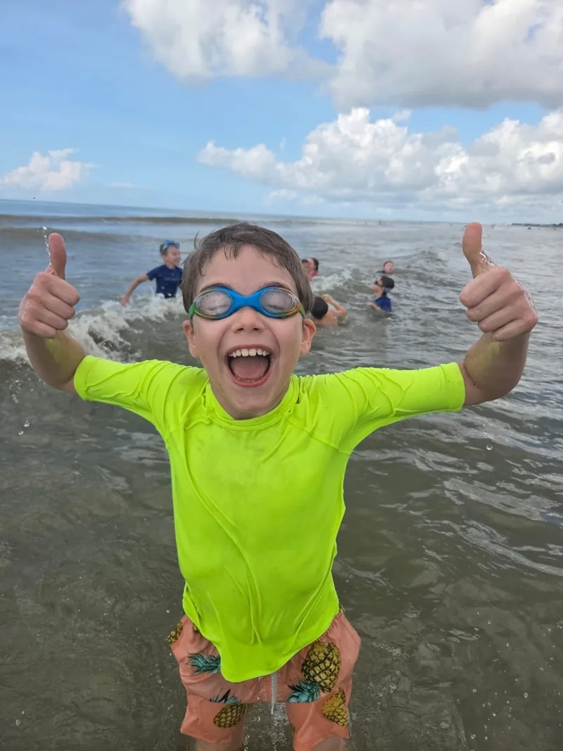 Swimmer giving two thumbs up in the ocean