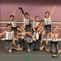 A teacher working directly with a dancer on placement