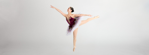 A Dance Connections dancer in an arabesque on pointe in a classical tutu