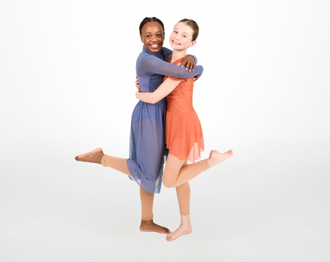 Two Dance Connections dancers embracing and smiling together