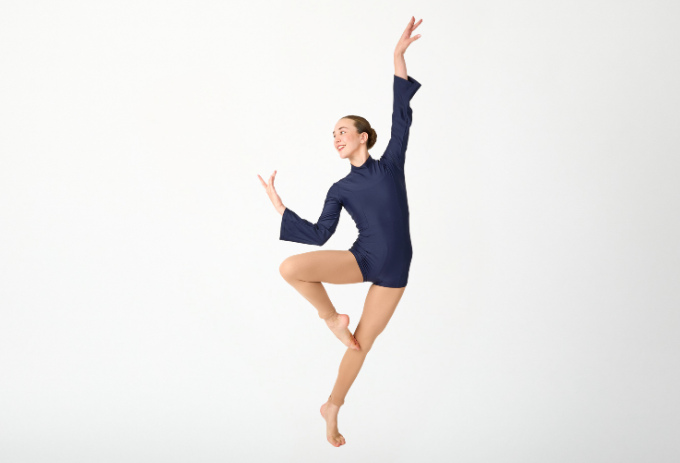 A Dance Connections dancer in a poised retiré, ready for the spring performance