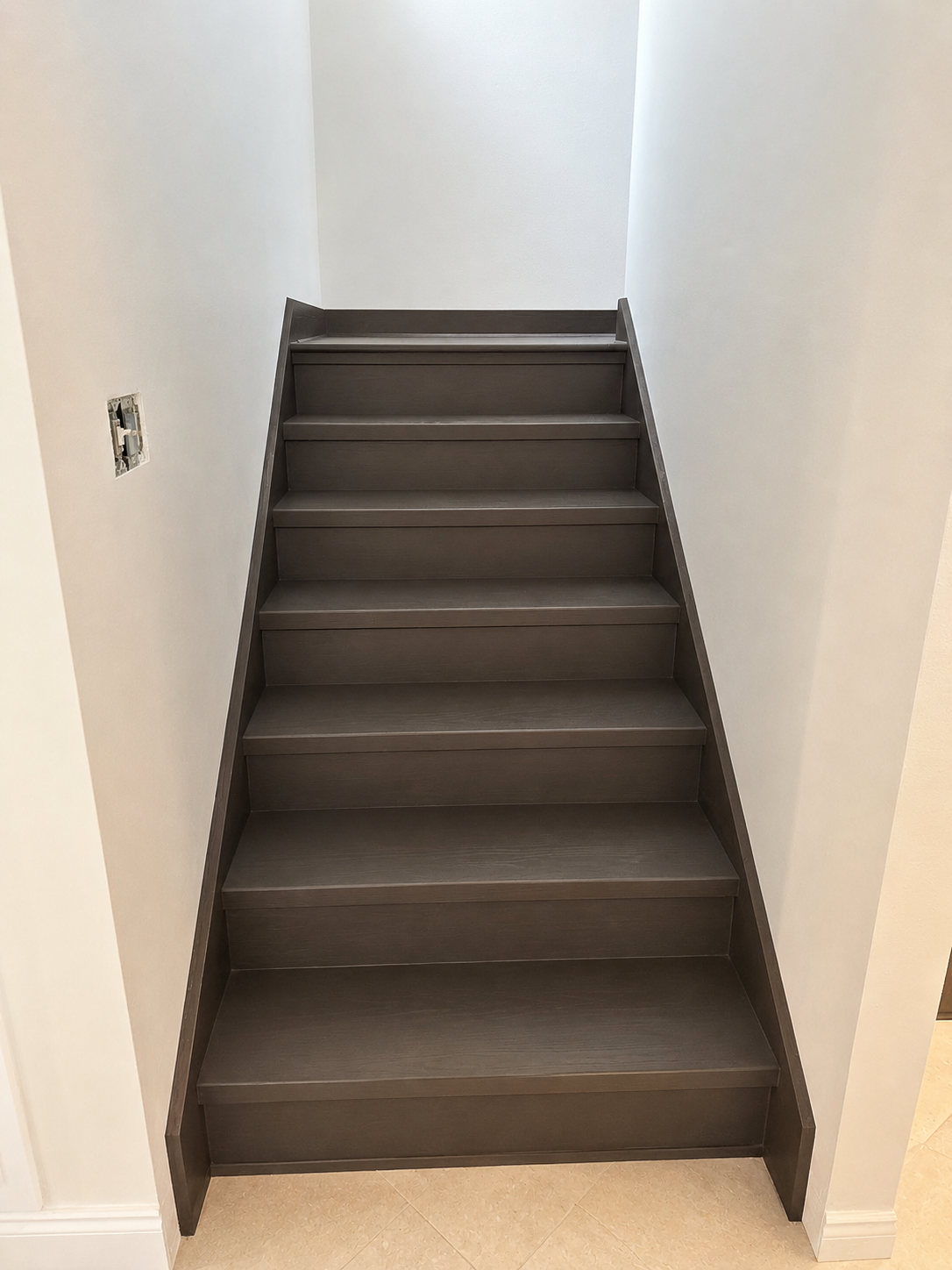 Dark gray LVP stair wrap staircase installation Central Florida - Protocol Home Services