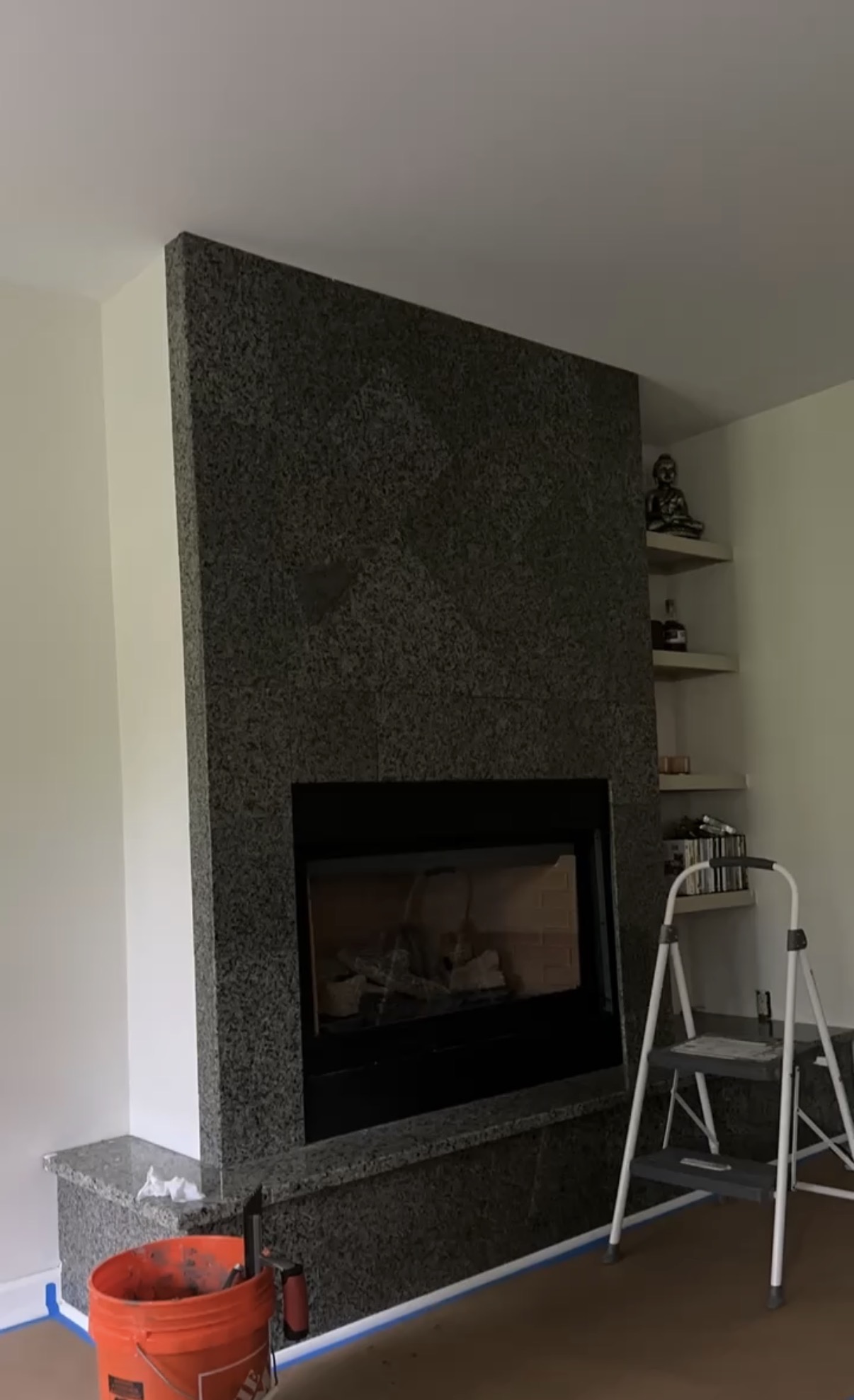 Dark granite tile fireplace surround before Roman clay finish Seminole County FL - Protocol Home Services