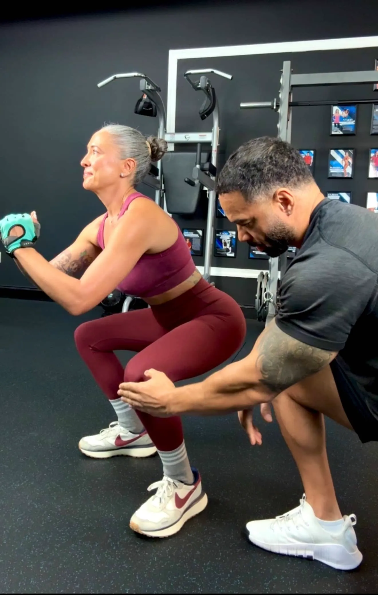 Coach CC Matthews guiding a client through a squat in the private Trinity Fitness personal training studio on Burns Road in Palm Beach Gardens
