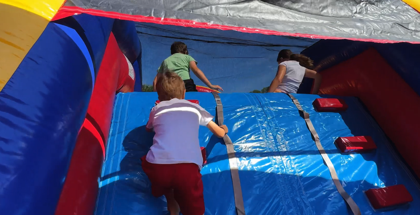 Kids climbing the obstacle course wall