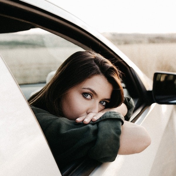 Woman leaning out of a car window
