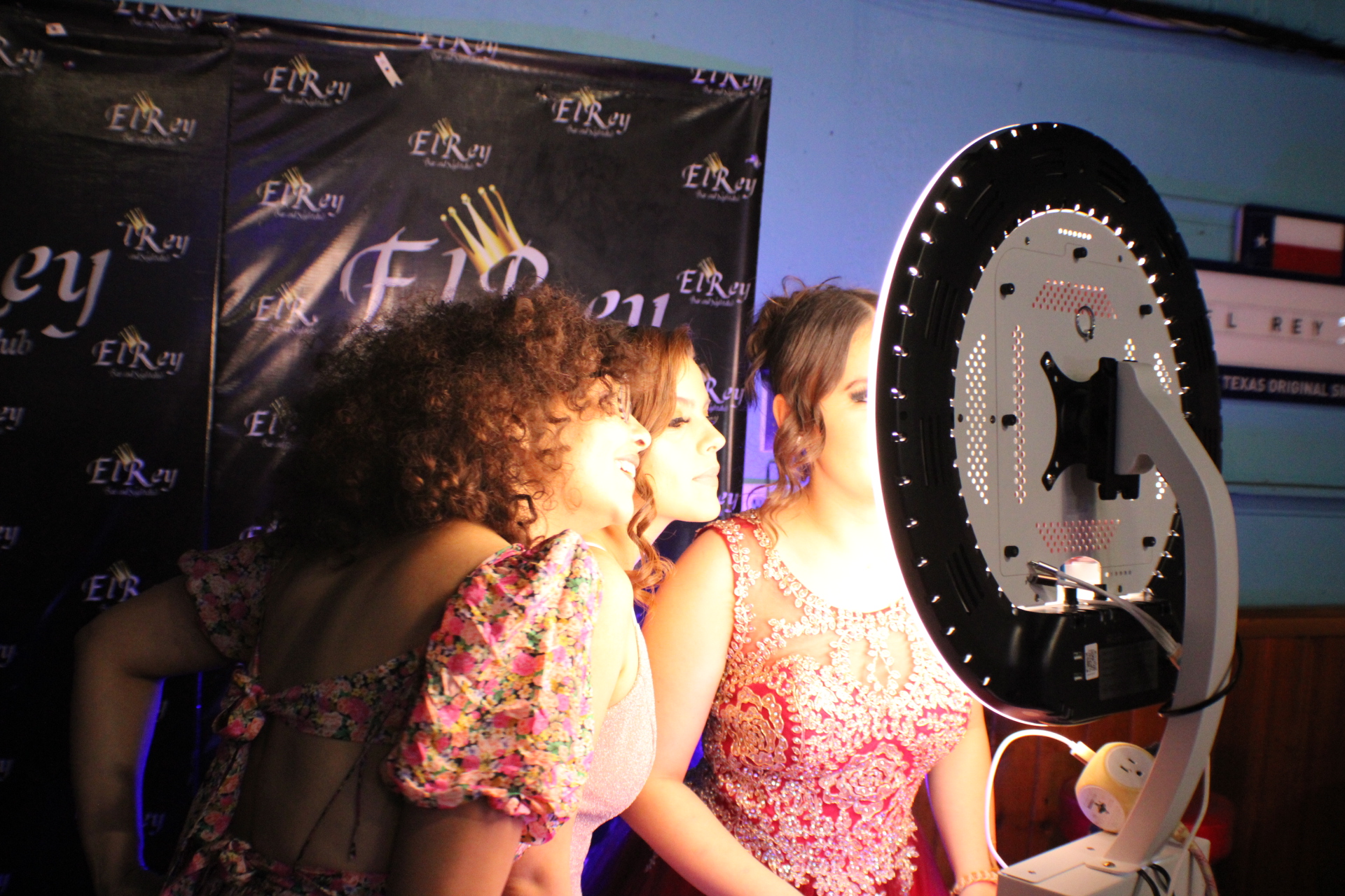 Guests at a photo booth during an indoor branded event in Central Texas