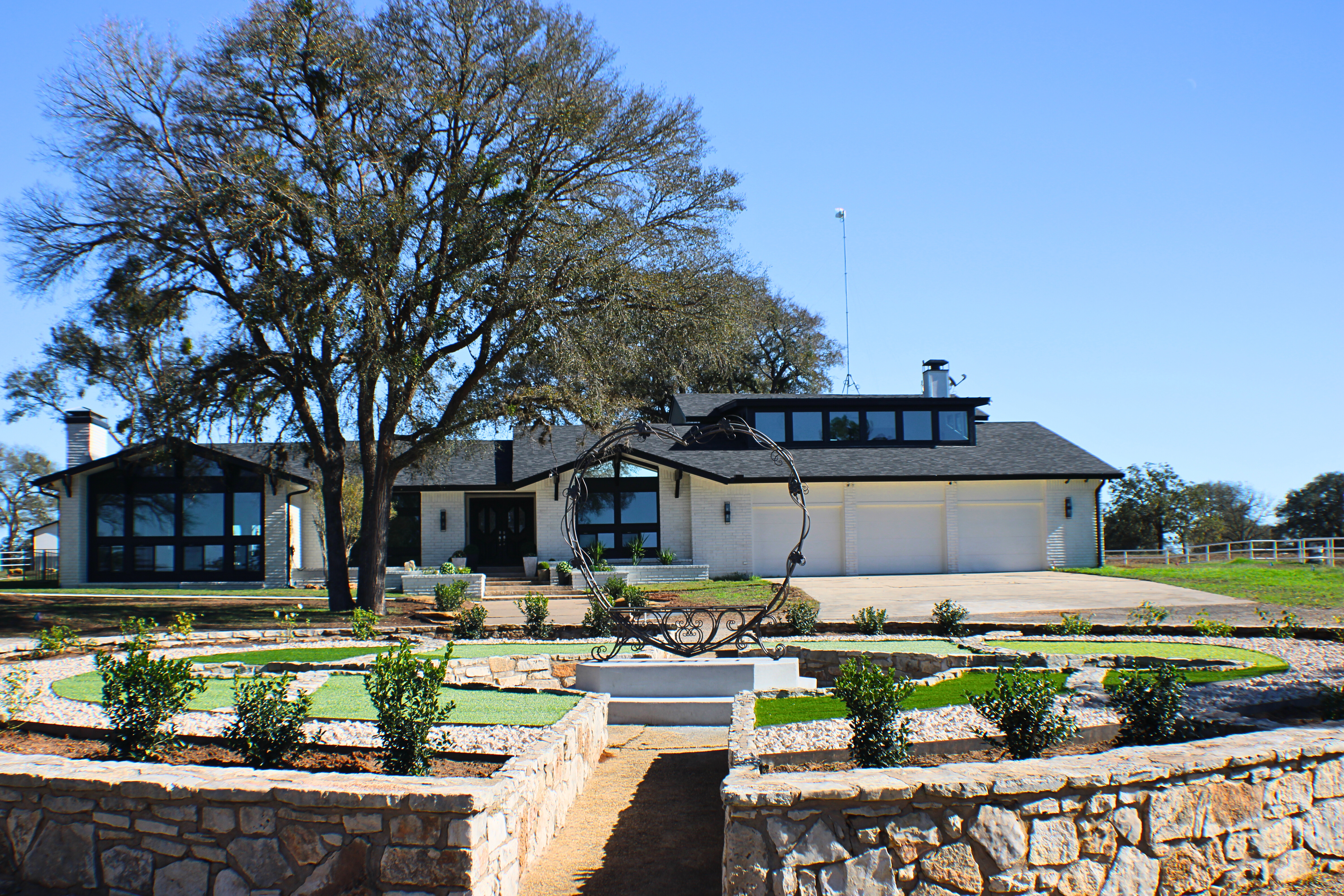 Exterior real estate photography of a Central Texas home with landscaped entry