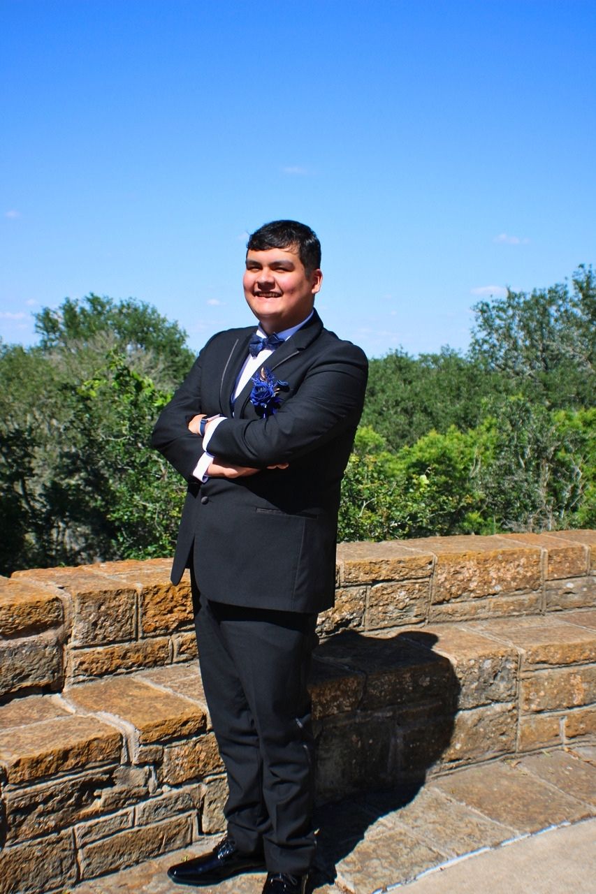 Outdoor formal portrait session against a stone wall in Central Texas