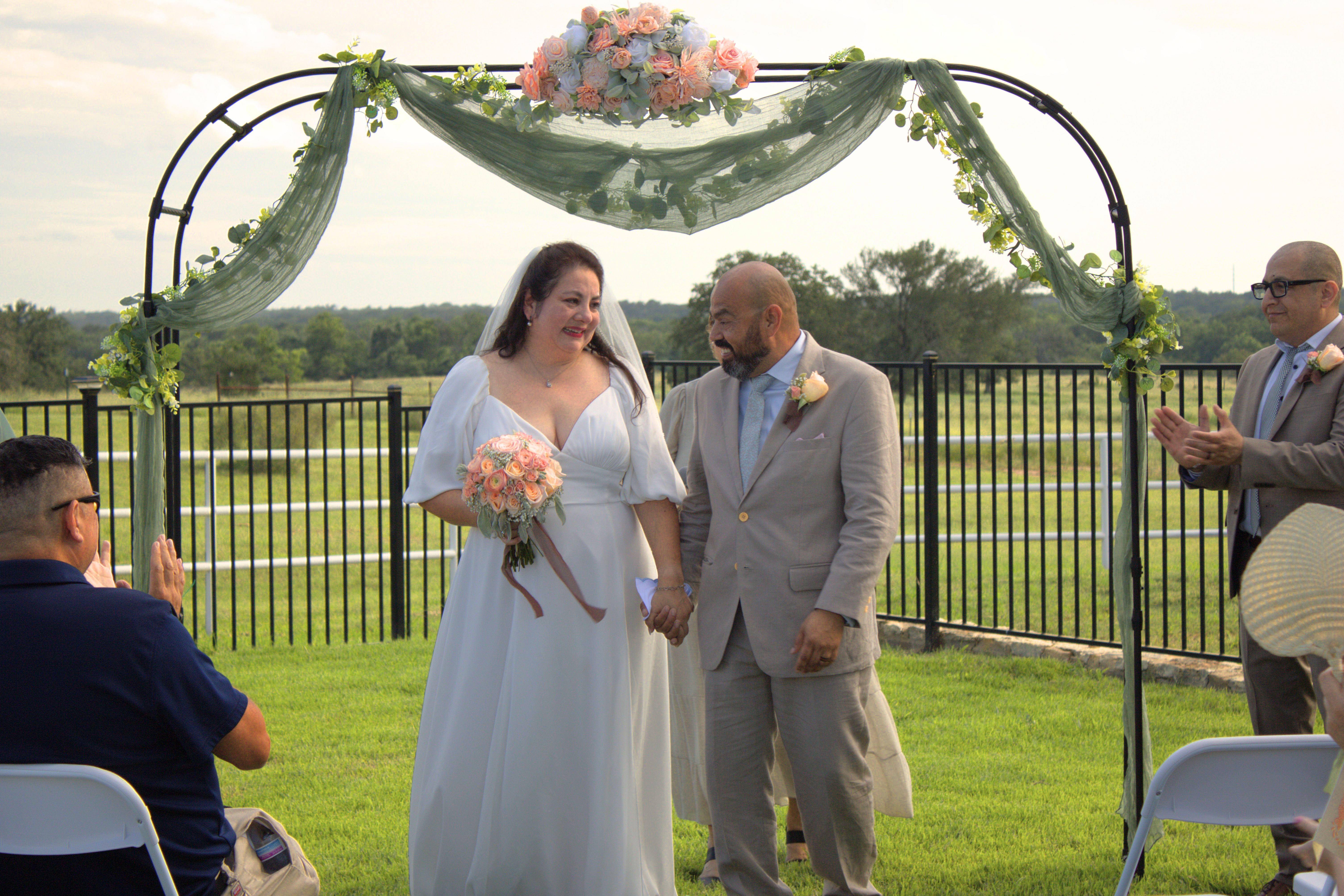 Couple at the ceremony arch during a wedding in Central Texas
