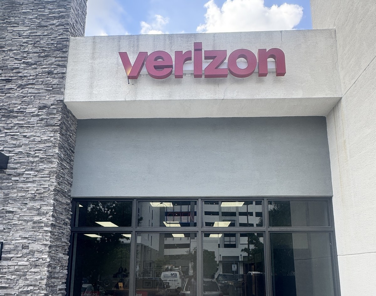 Red channel letters on a raceway above a retail storefront in Hialeah