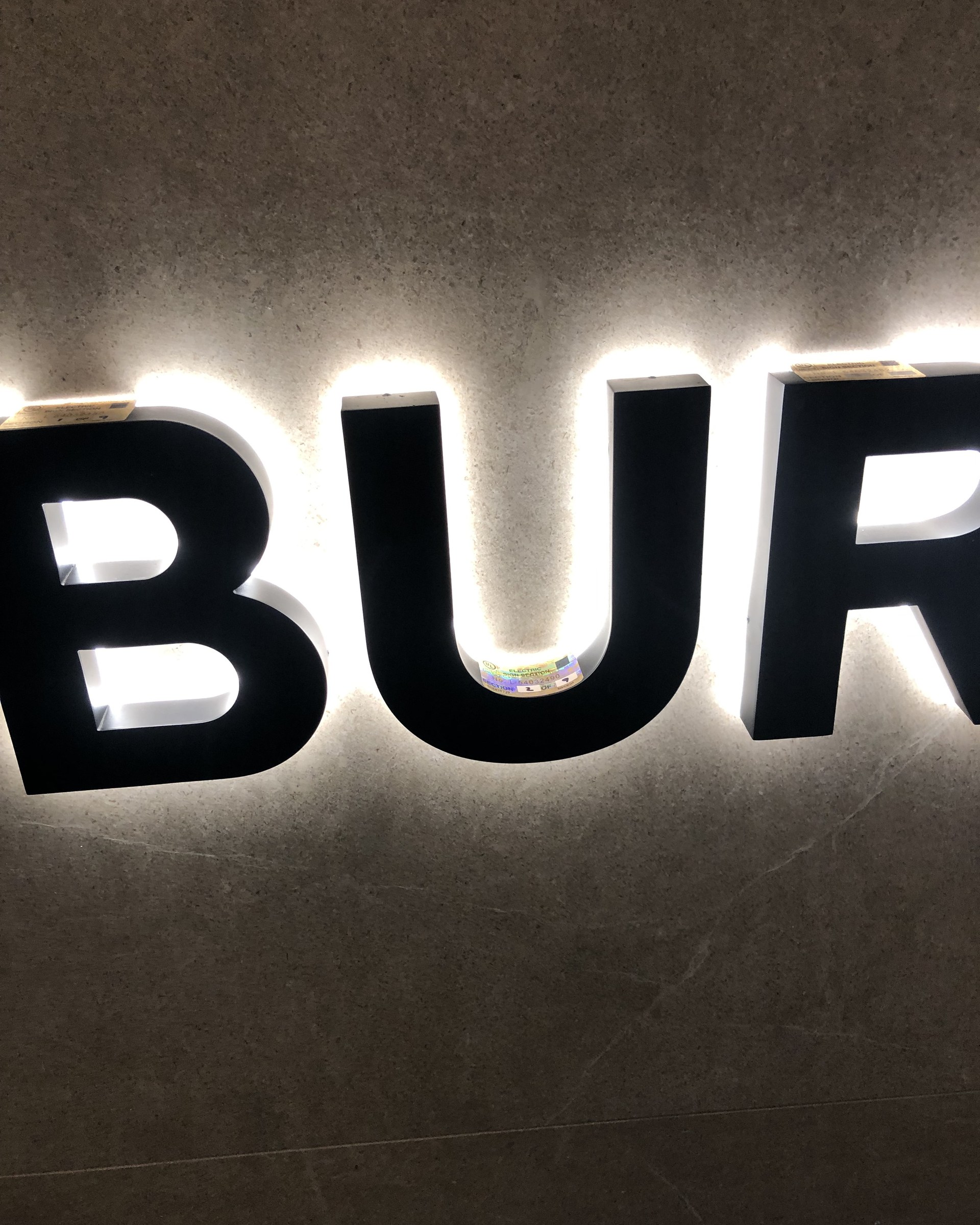Halo-lit reverse channel letters glowing against a dark wall