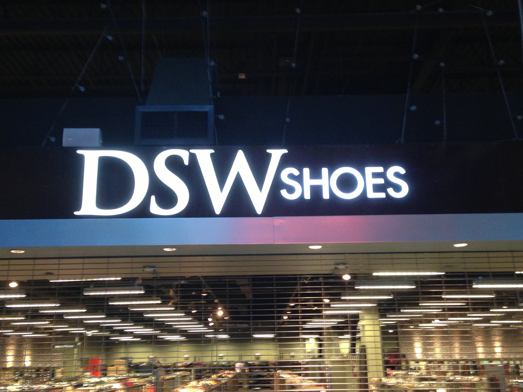 Front-lit white channel letters above a retail store entrance