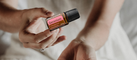 woman holding a bottle of geranium woman holding a bottle of geranium