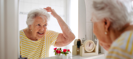 Grandma checking her hair in a mirror