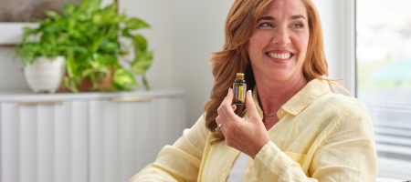 woman holding lemon essential oil