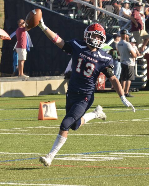 A football player running with the ball during a game.