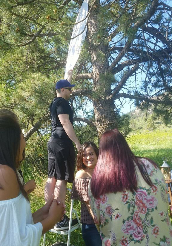 Carols Crew senior ambassador team group photo in front of school bus eaton colorado