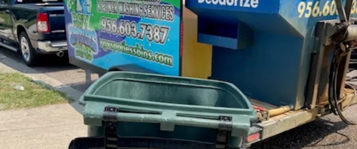 Green garbage bin during professional trash can cleaning process