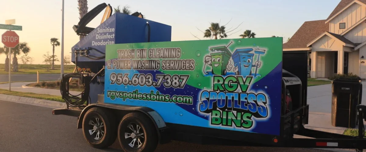 A custom RGV Spotless Bins trailer displaying trash bin cleaning services with a stop sign in the background. A custom RGV Spotless Bins trailer displaying trash bin cleaning services with a stop sign in the background.