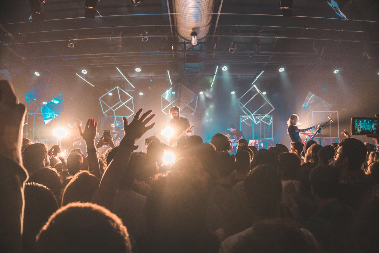 Live music concert crowd with hands raised