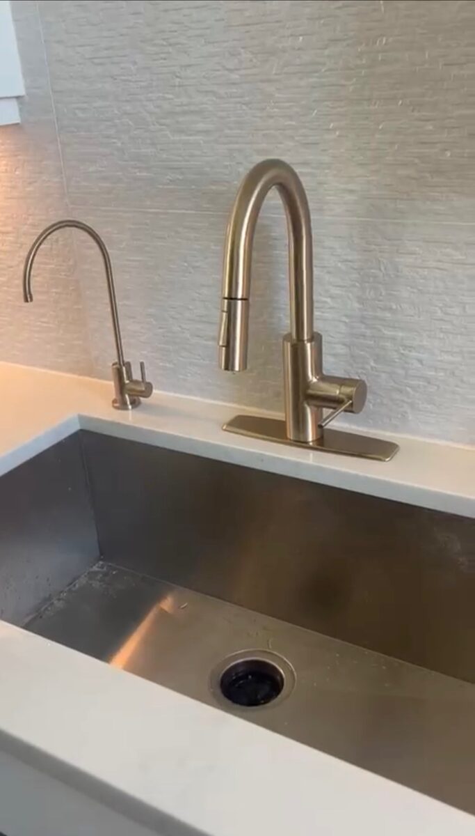 Reverse osmosis drinking faucet next to main kitchen faucet