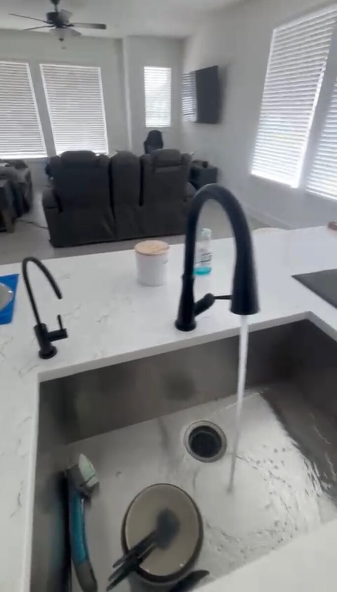 Filtered water flowing from an installed kitchen faucet