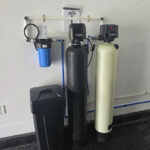 Sediment pre-filter with softener and filtration tanks installed in a garage