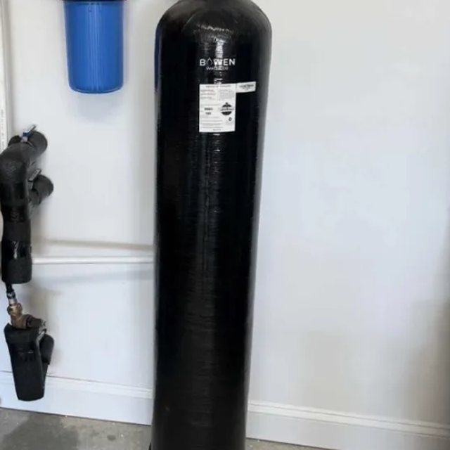Whole-home filtration tank with blue sediment pre-filter