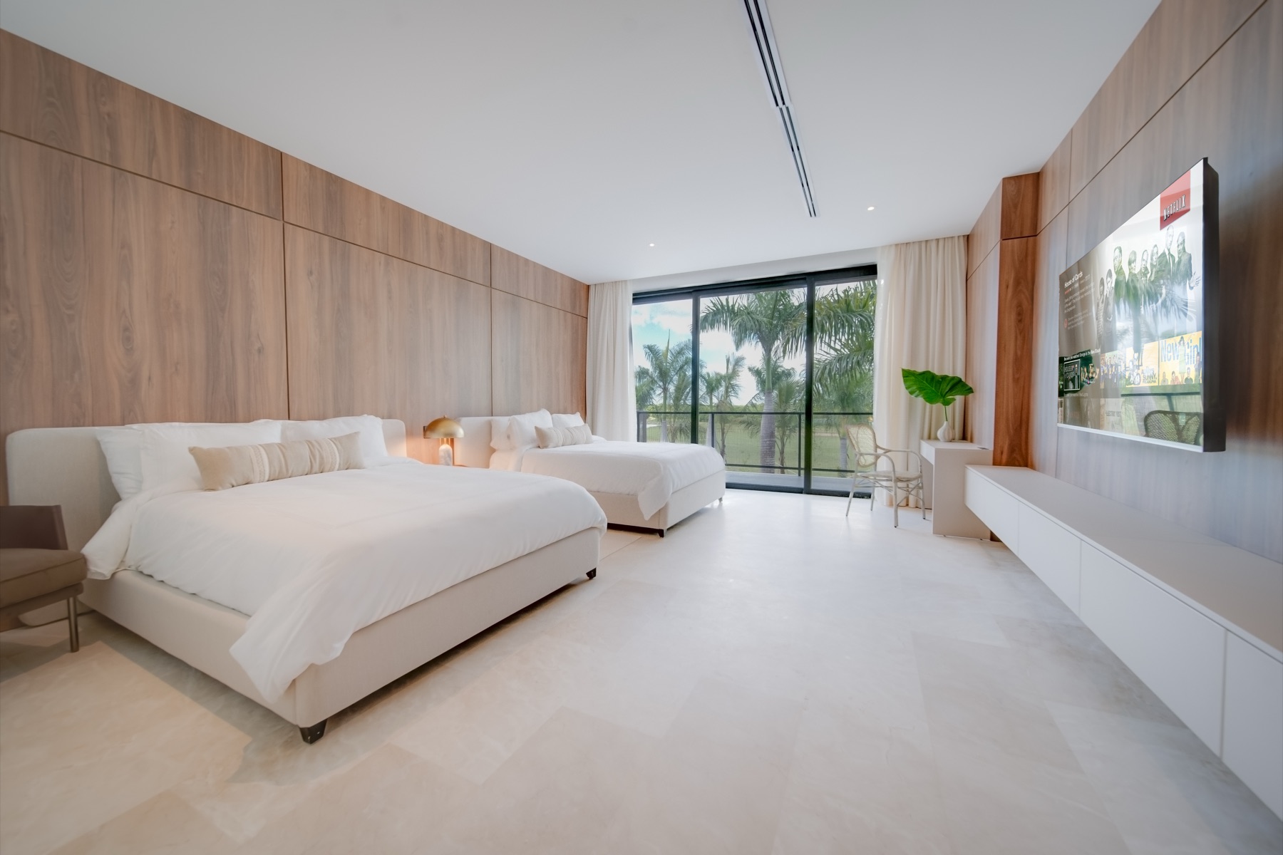 Guest suite with two queen beds and palm view