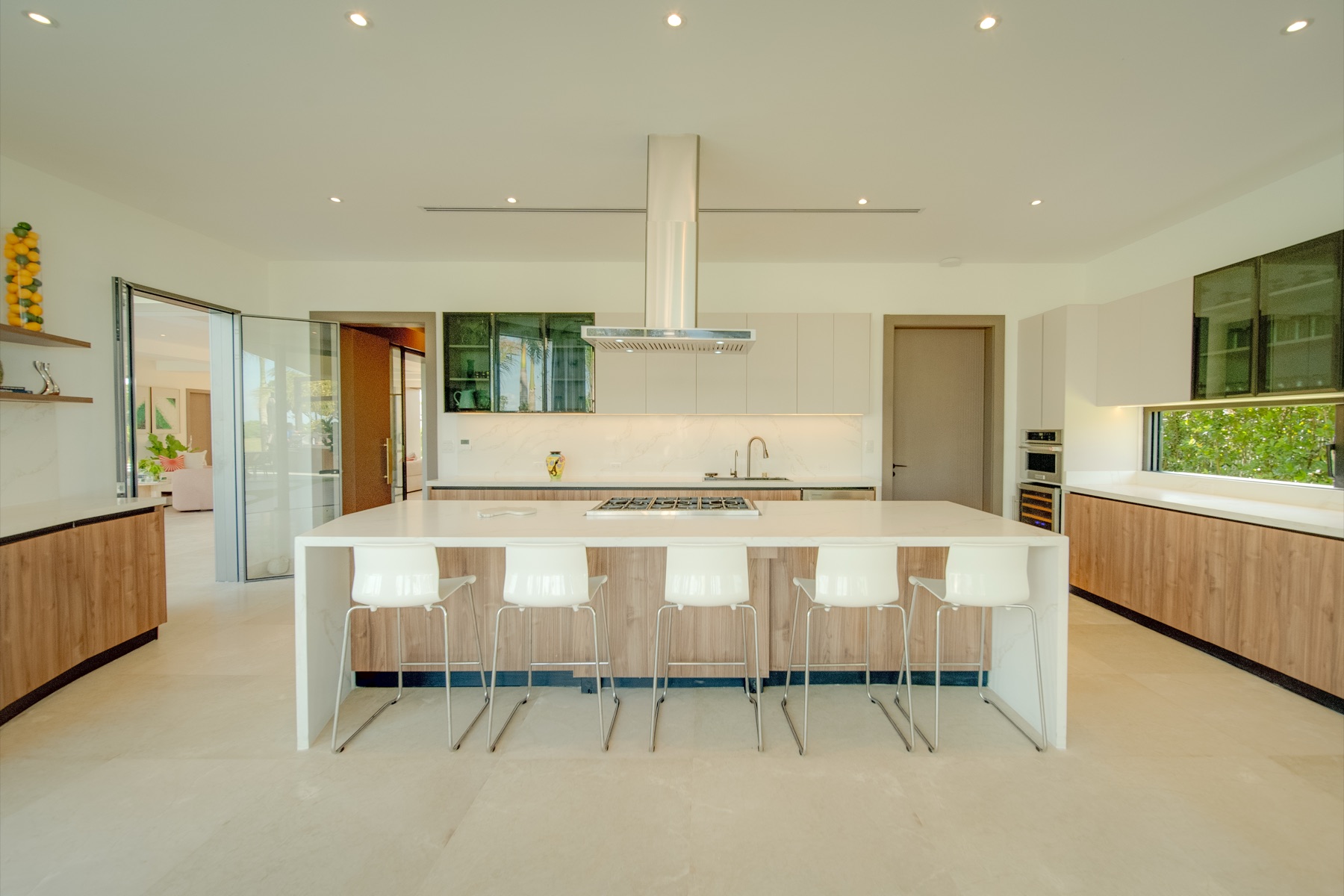 Kitchen island with white stools and marble counters