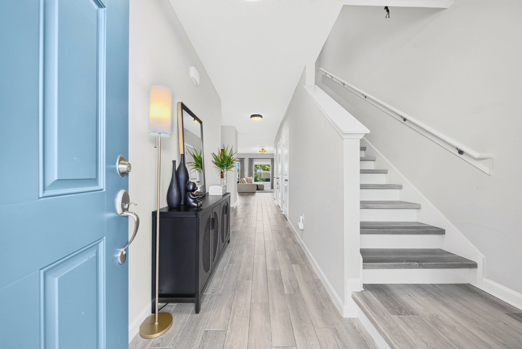 Entry hall with blue front door and staircase, Orlando listing