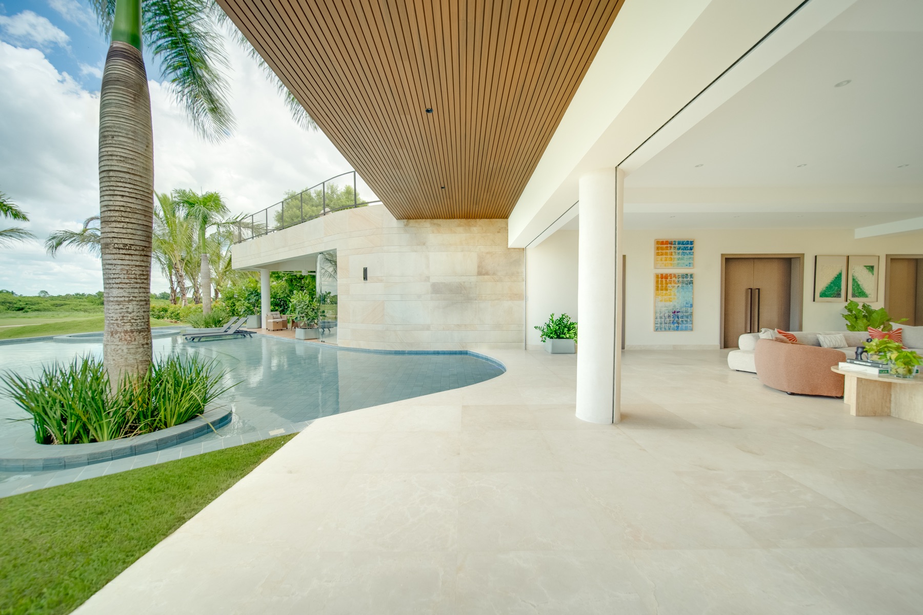 Pool wrapping the covered terrace into the living room