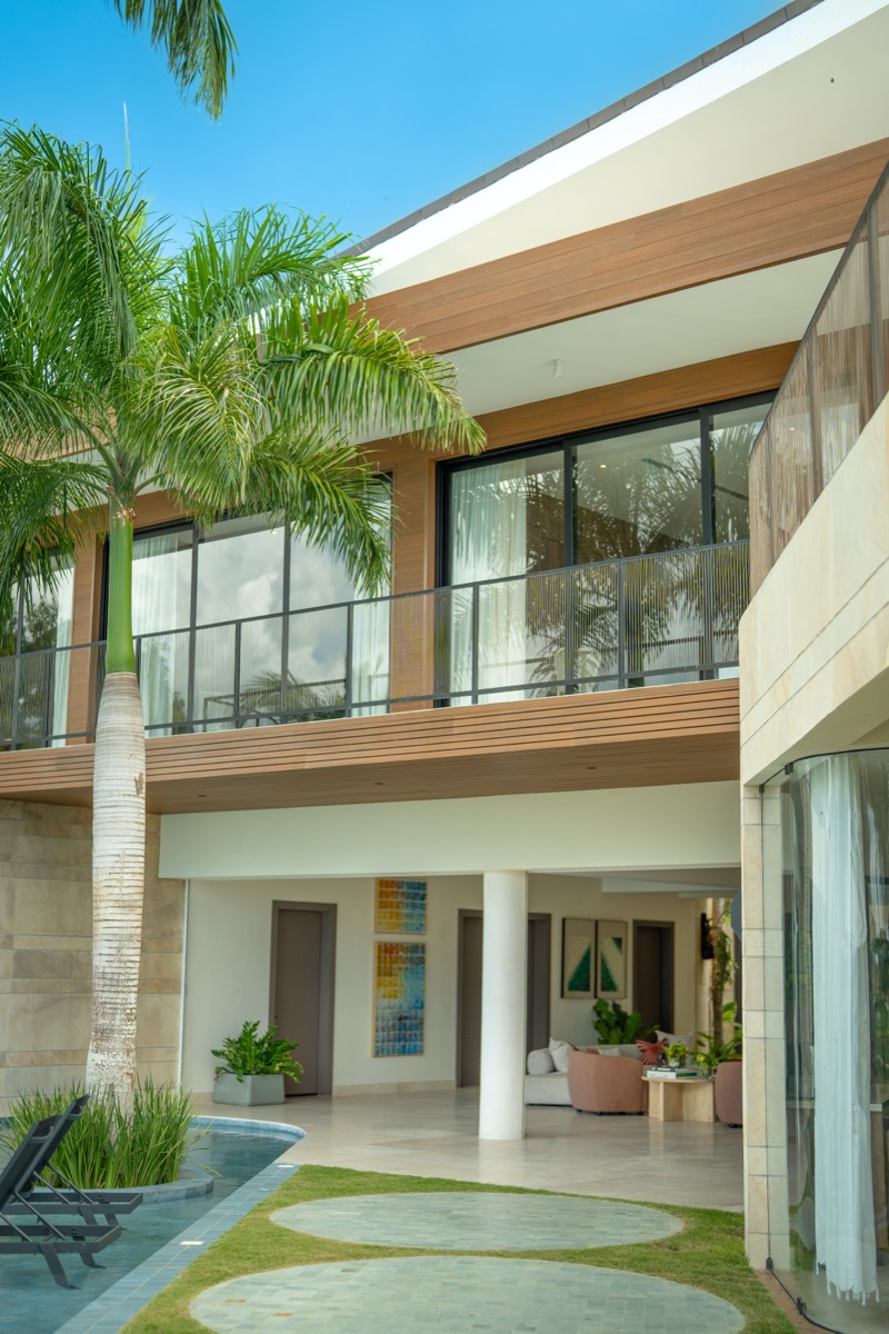 Two-story courtyard with palm, pool edge and lounge, Casa de Campo
