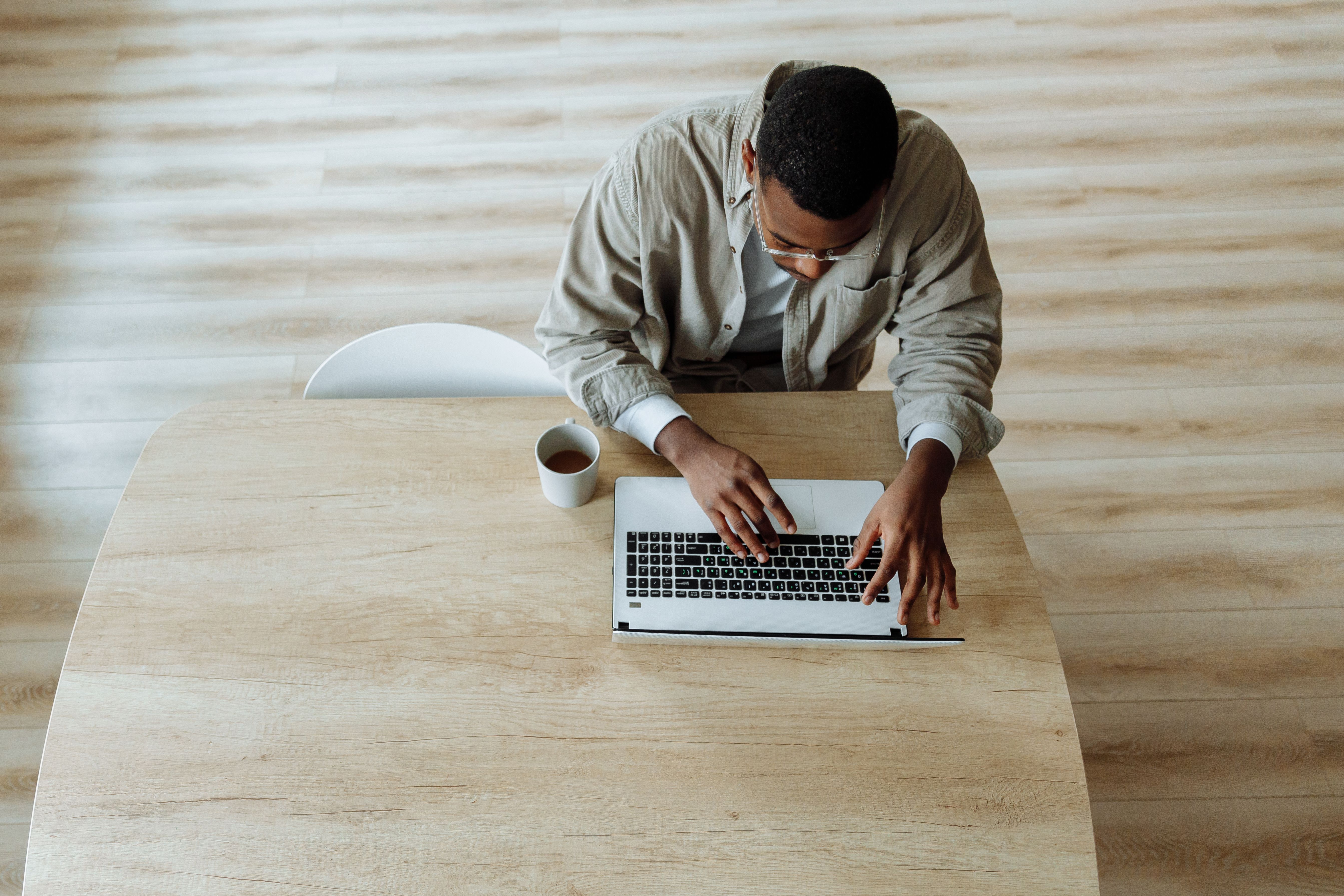 Man reviewing his health benefits on a laptop at his desk Man reviewing his health benefits on a laptop at his desk
