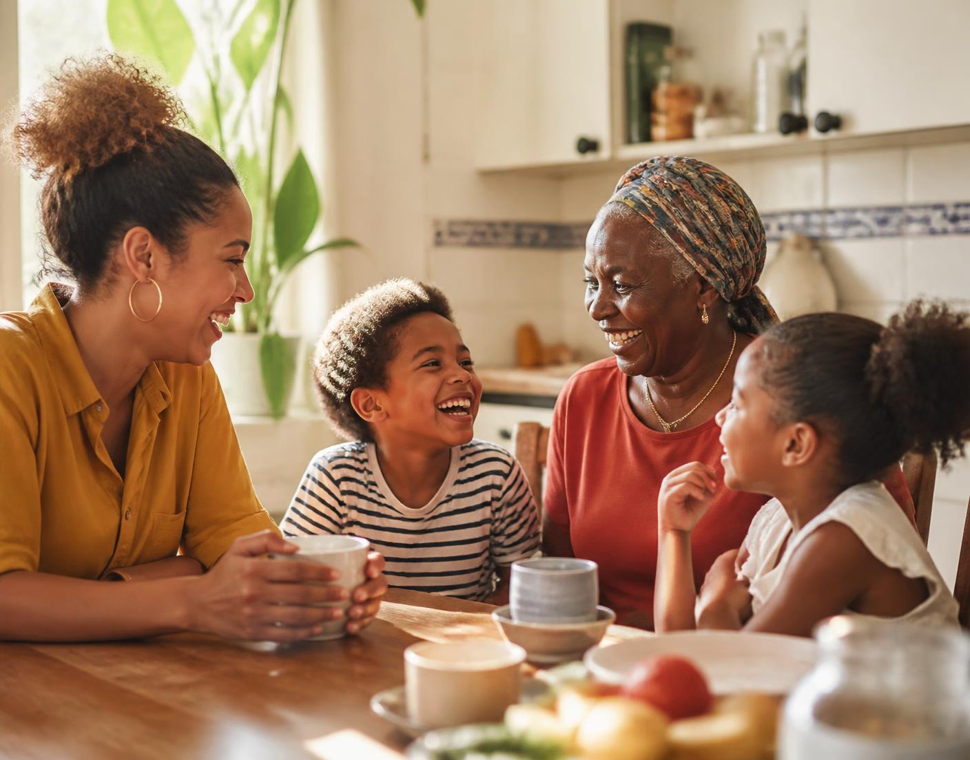 A multigenerational family talking and laughing together around a table.