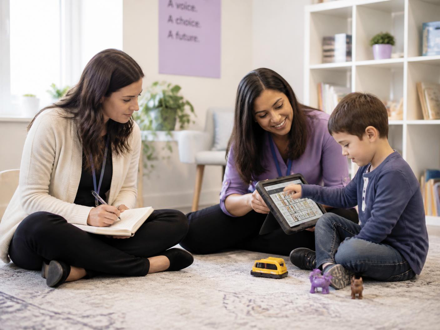 Speech-language professionals collaborating with an AAC communication board
