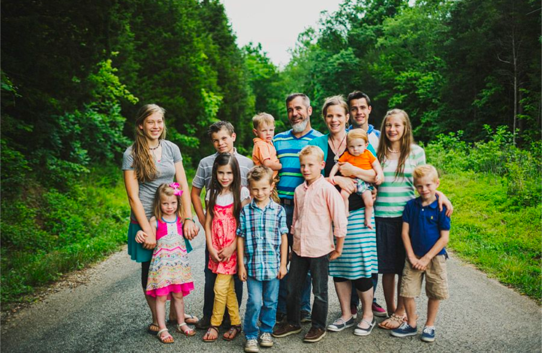 The Vincent family together on a tree-lined country road