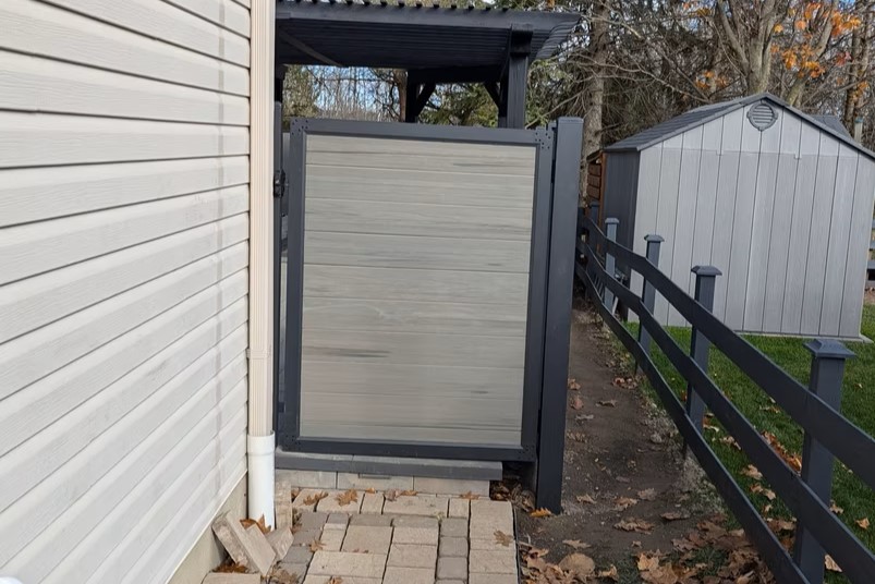 Gray composite privacy fence gate in Casselman
